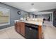 Kitchen island features a stainless steel sink, granite countertops, and modern black dishwasher at 5660 Elsinore Way, Lakeland, FL 33805
