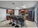 Kitchen with breakfast bar seating, dark cabinetry, and stainless steel appliances at 5660 Elsinore Way, Lakeland, FL 33805