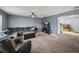 Comfortable living room with a ceiling fan, plush seating, and neutral gray walls at 5660 Elsinore Way, Lakeland, FL 33805