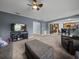 Cozy living room with open concept kitchen views, plush carpeting, and an entertainment center at 5660 Elsinore Way, Lakeland, FL 33805