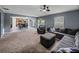 Open-concept living room with views of the kitchen, plush carpeting, and ample seating at 5660 Elsinore Way, Lakeland, FL 33805