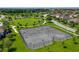 Large fenced tennis and basketball courts area with landscaping and walking paths around the community at 5660 Elsinore Way, Lakeland, FL 33805