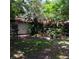 Backyard view with green space and chairs, shaded by trees, offering a tranquil outdoor retreat at 6615 New Tampa Highway, Lakeland, FL 33815