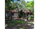 Backyard view with green space and chairs, shaded by trees, offering a tranquil outdoor retreat at 6615 New Tampa Highway, Lakeland, FL 33815
