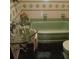 Quaint bathroom featuring vintage green fixtures, including a tub and sink with a glass vanity at 6615 New Tampa Highway, Lakeland, FL 33815
