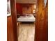Primary bedroom with wood panel walls and decorative wall hangings at 6615 New Tampa Highway, Lakeland, FL 33815