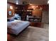 Comfortable bedroom featuring wood paneling, a cozy bed, and ample storage space at 6615 New Tampa Highway, Lakeland, FL 33815