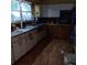 Traditional kitchen with stainless steel appliances, two-tone cabinets and wood-look flooring at 6615 New Tampa Highway, Lakeland, FL 33815