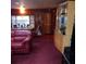 Large living area with wood-paneled walls and ample space at 6615 New Tampa Highway, Lakeland, FL 33815