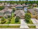 Aerial view of a home with well-maintained landscaping, a front yard, and a driveway at 1111 Bassano Way, Orlando, FL 32828