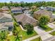 Aerial view of a single Gathering home in a residential neighborhood with mature trees and lush lawns at 1111 Bassano Way, Orlando, FL 32828