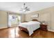 Bright bedroom with a ceiling fan, large window, and hardwood flooring at 1111 Bassano Way, Orlando, FL 32828