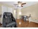 Relaxing bedroom featuring a massage chair, ceiling fan and light wood floors at 1111 Bassano Way, Orlando, FL 32828