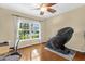 Bright bedroom featuring hardwood floors and large window with lush green scenery at 1111 Bassano Way, Orlando, FL 32828