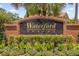 Waterford Trails neighborhood brick sign surrounded by lush landscaping at 1111 Bassano Way, Orlando, FL 32828