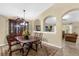 Dining room with wooden table and chairs, decorative rug, and an ornate hutch at 1111 Bassano Way, Orlando, FL 32828