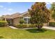 Charming home featuring well-maintained landscaping and a healthy, mature tree in the front yard at 1111 Bassano Way, Orlando, FL 32828