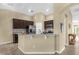 A modern kitchen featuring stainless steel appliances, granite countertops, and a breakfast bar at 1111 Bassano Way, Orlando, FL 32828