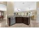 Spacious kitchen with granite countertops, stainless steel dishwasher, and breakfast bar open to the living area at 1111 Bassano Way, Orlando, FL 32828