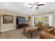Cozy living room with a large window, ceiling fan and a TV at 1111 Bassano Way, Orlando, FL 32828