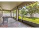 Screened patio with views of the landscaped yard and trees, perfect for enjoying the outdoors at 1111 Bassano Way, Orlando, FL 32828