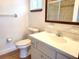 Well-lit bathroom with a modern sink, toilet, and a large mirror at 8386 Sw 105Th Pl, Ocala, FL 34481