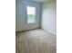 Inviting bedroom featuring carpet flooring, a window with a scenic view, and ample natural light at 5543 Siltstone St, Lakeland, FL 33811