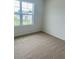 Comfortable bedroom featuring carpet flooring, a window with a serene view, and ample natural light at 5543 Siltstone St, Lakeland, FL 33811