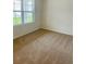 Neutral bedroom with carpet flooring and a large window offering natural light at 5543 Siltstone St, Lakeland, FL 33811