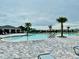 Resort-style community pool with palm trees, lounge chairs, and a nearby clubhouse for residents to enjoy at 5543 Siltstone St, Lakeland, FL 33811
