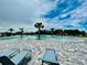 Spacious community pool area with lounge chairs and picturesque palm trees, perfect for relaxation at 5543 Siltstone St, Lakeland, FL 33811