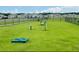 Well-maintained dog park featuring a secure fence, lush green grass, and various agility obstacles for active pets at 5543 Siltstone St, Lakeland, FL 33811