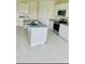 Bright kitchen featuring white cabinetry, granite countertops, and stainless steel appliances at 5543 Siltstone St, Lakeland, FL 33811