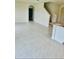 Spacious living room featuring tile flooring, an open layout, and a view of the staircase and bathroom at 5543 Siltstone St, Lakeland, FL 33811