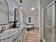 A bathroom featuring double sinks, granite countertops, a tub and stand-alone shower at 5790 Cherry Tree Dr, Lakeland, FL 33811