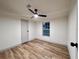 Another bedroom with hardwood floors features a ceiling fan and a single window at 5790 Cherry Tree Dr, Lakeland, FL 33811