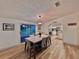 Open-concept dining area with stylish furniture, wood floors, and access to a screened porch at 5790 Cherry Tree Dr, Lakeland, FL 33811