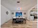 Well-lit dining area with a modern table set, view to the kitchen, and hardwood floors at 5790 Cherry Tree Dr, Lakeland, FL 33811