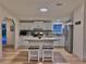 Bright kitchen with stainless steel appliances, a kitchen island, and tile backsplash at 5790 Cherry Tree Dr, Lakeland, FL 33811