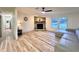 Large living room with hardwood floors, stone fireplace, a ceiling fan and a large window at 5790 Cherry Tree Dr, Lakeland, FL 33811