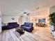 Spacious living room featuring modern furnishings, wood-look flooring, and ample natural light at 5790 Cherry Tree Dr, Lakeland, FL 33811