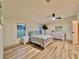 Bright and airy main bedroom with a ceiling fan, wood-look floors, and plenty of natural light at 5790 Cherry Tree Dr, Lakeland, FL 33811