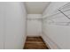 Walk-in closet with wood floors, white walls, and metal shelving for ample storage space at 5790 Cherry Tree Dr, Lakeland, FL 33811