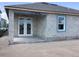 View of new home's exterior with covered patio featuring large windows and concrete block construction at 5722 Cattle Ranch Drive, St Cloud, FL 34771