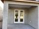 Covered outdoor patio with double doors, offers shade and extends the living space at 5722 Cattle Ranch Drive, St Cloud, FL 34771
