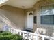 Close-up view of the brick facade and covered entryway of a single-Gathering home at 9859 Sw 97Th St, Ocala, FL 34481