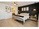 A modern bedroom includes a dark accent wall and 