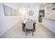 Bright dining room with a wooden table, upholstered chairs, and view to the entry and kitchen at 10274 Julia Isles Ave, Oxford, FL 34484