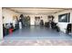 Spacious two car garage with epoxied floors is well organized and includes lots of space for storage at 10274 Julia Isles Ave, Oxford, FL 34484