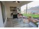Screened patio with a seating area, ceiling fan and grill is great for outdoor entertaining at 10274 Julia Isles Ave, Oxford, FL 34484